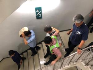負傷者を運びながら慎重に階段を下りる様子
